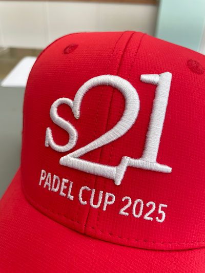 red baseball cap with tight logo embroidery stitching