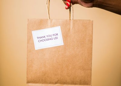 brown shopping bag with thank you note